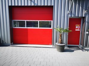 Privat - Sektionaltor mit Nebentüre und Fenstersektion Kleinsicke stucco RAL3000 rot in Niederbüren